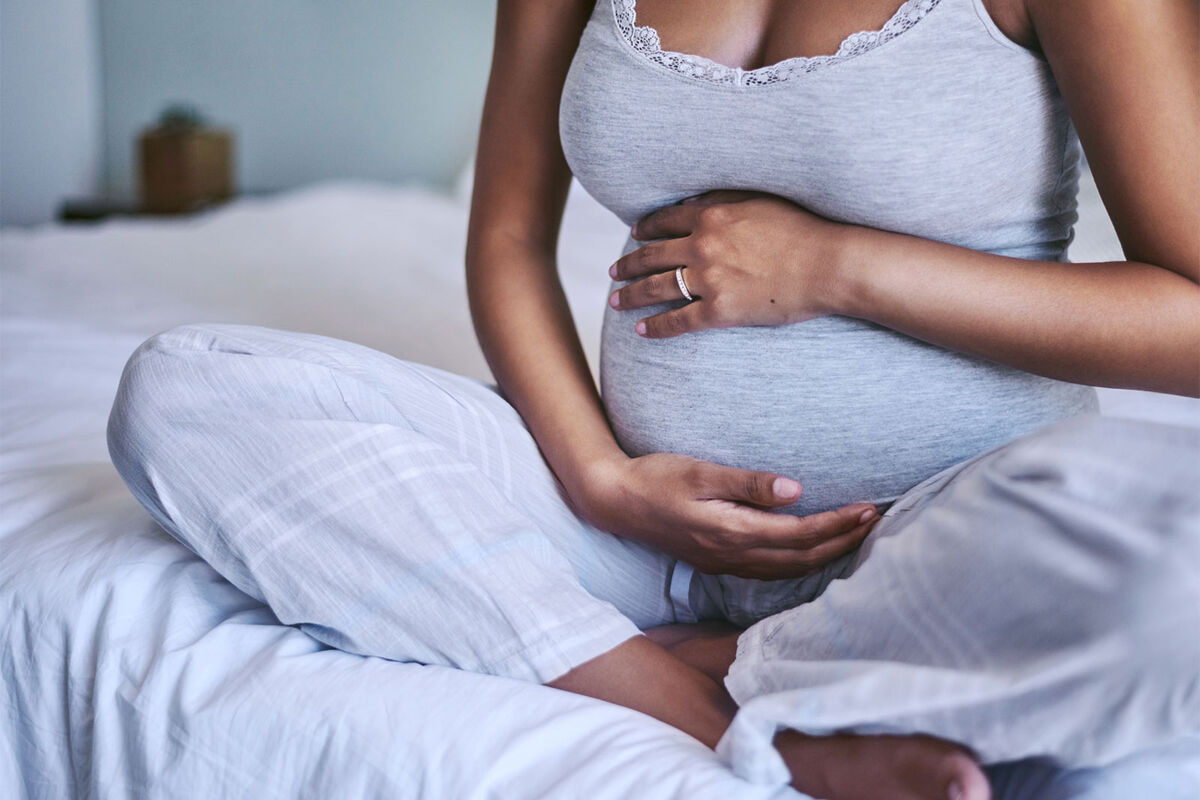 pregnant person holding belly