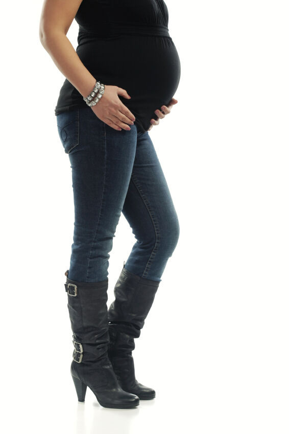 Expectant mom wearing fashionable maternity jeans