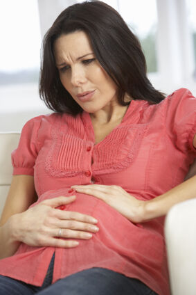 A pregnant woman experiencing abdominal discomfort