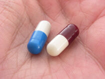 Sleeping pills in the palm of a woman's hand