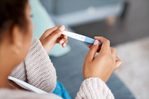 Woman taking a pregnancy test at home