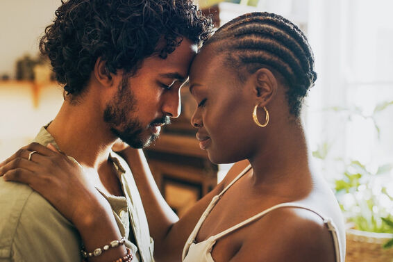 couple standing together and sharing an intimate moment at home