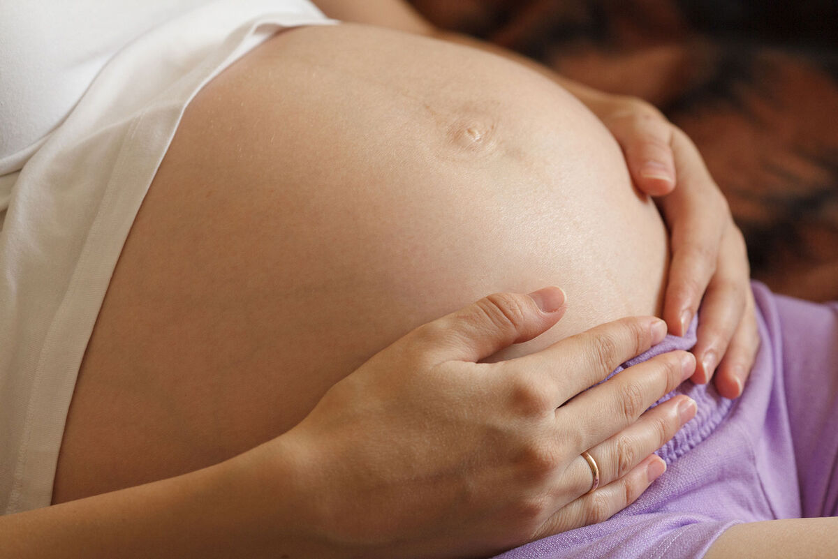 woman holding pregnant belly