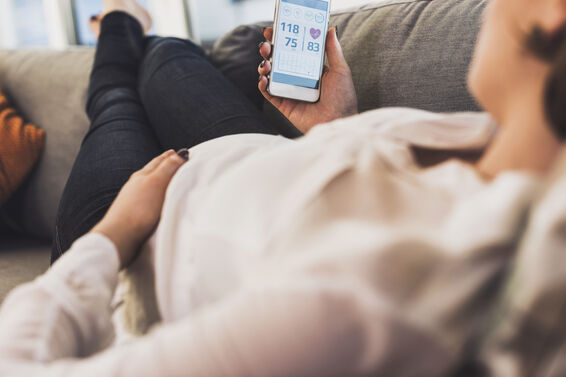 Pregnant woman using smartphone for health
