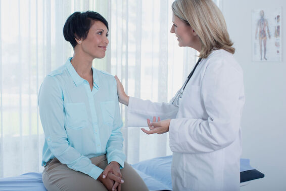 Doctor talking with female patient