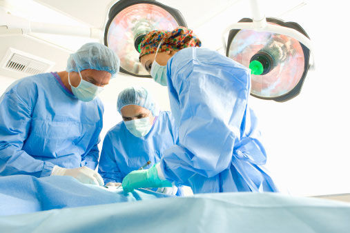 Surgeons operating on patient