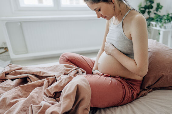 young expectant mother stroking her baby bump