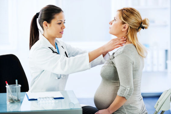 doctor examing patient with sore throat