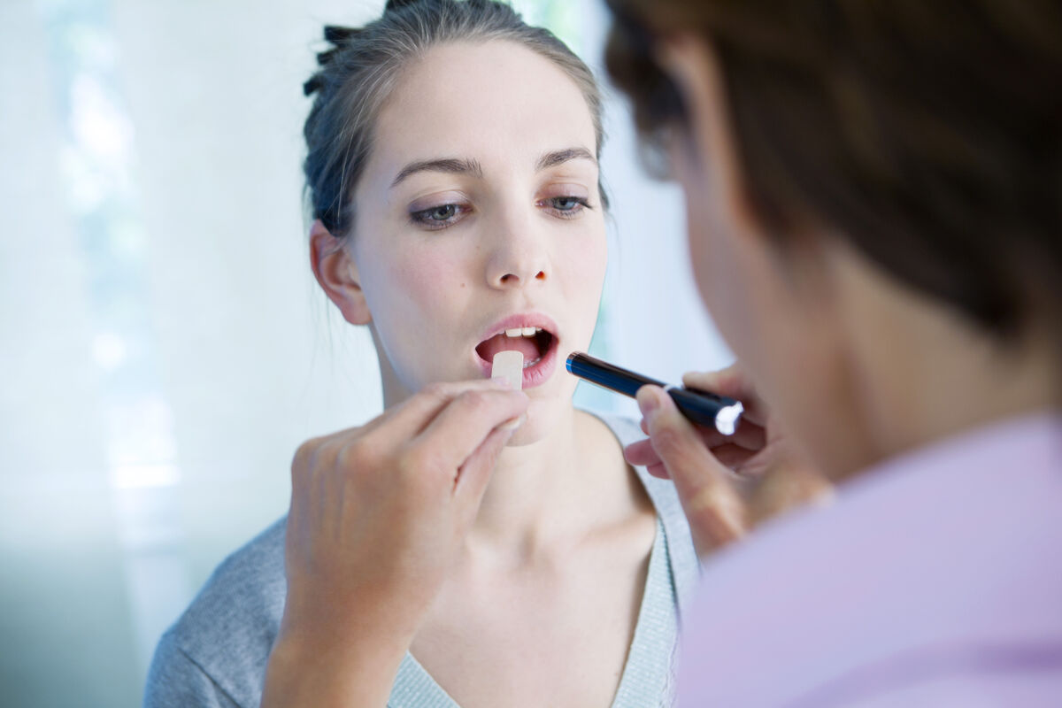 woman having throat examined