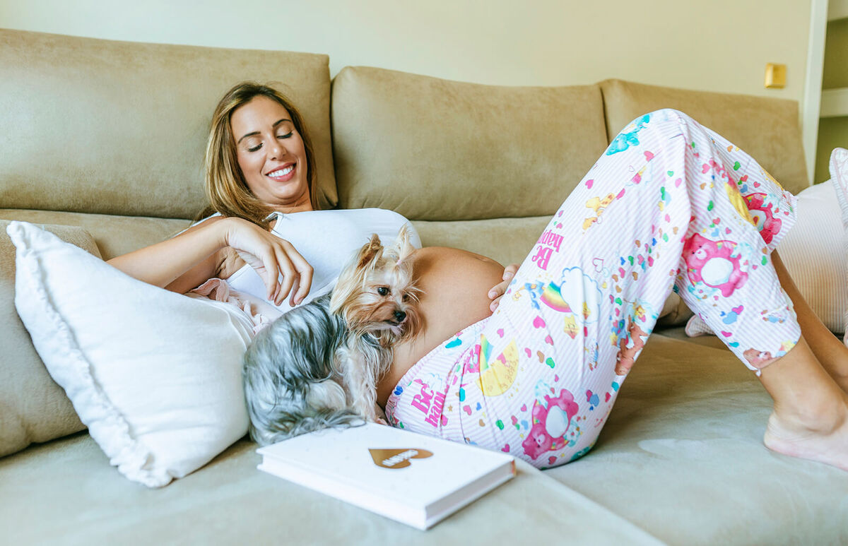 Pregnant woman and dog lying down