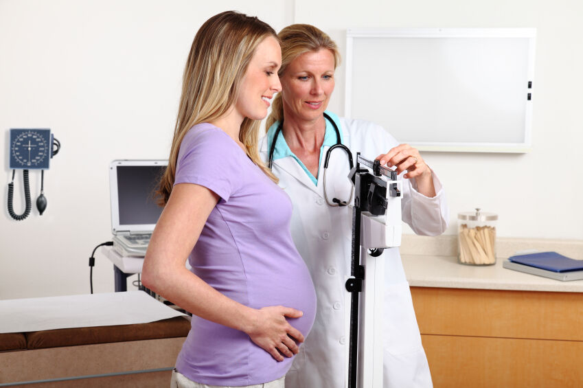 Pregnant woman on a scale during a checkup