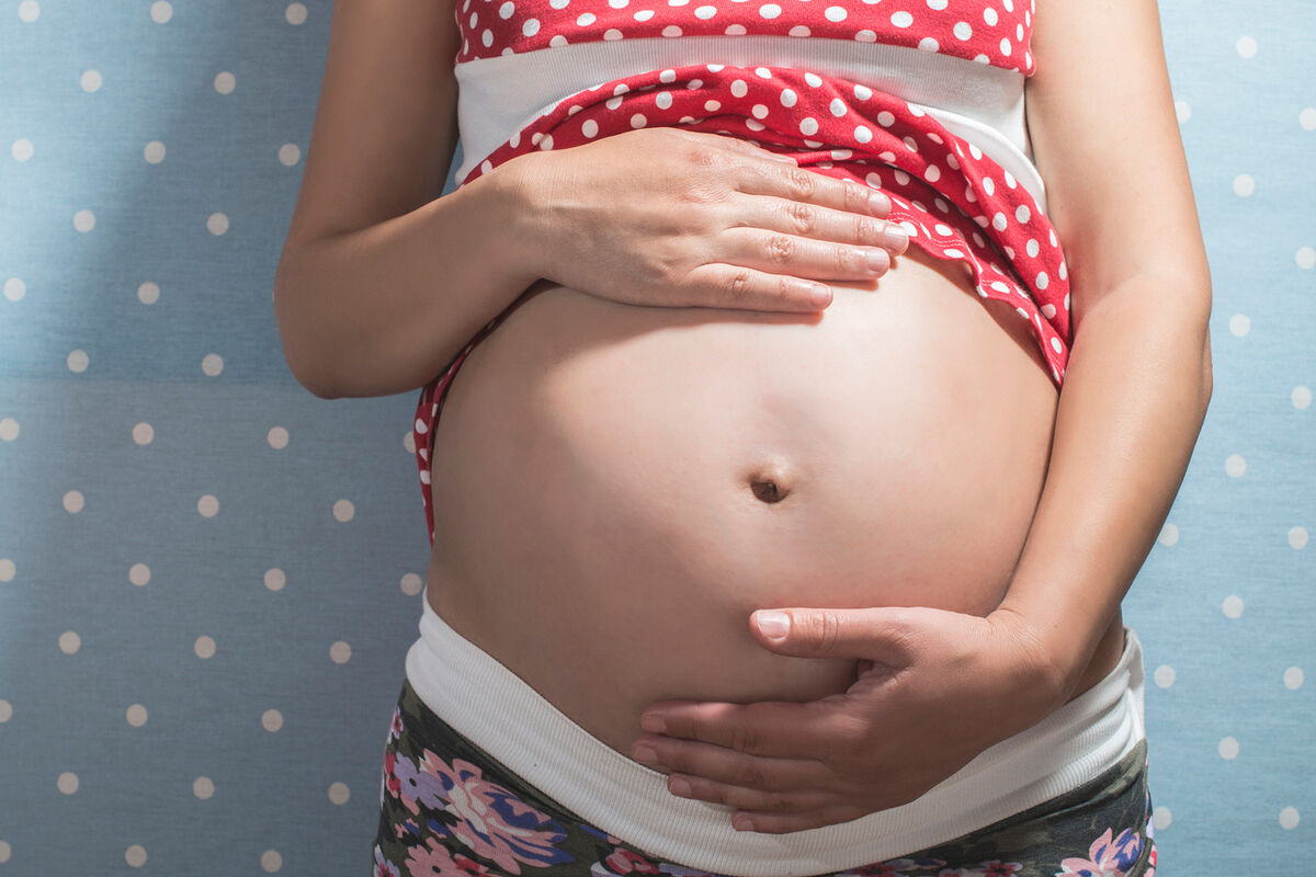 Woman holding pregnant belly