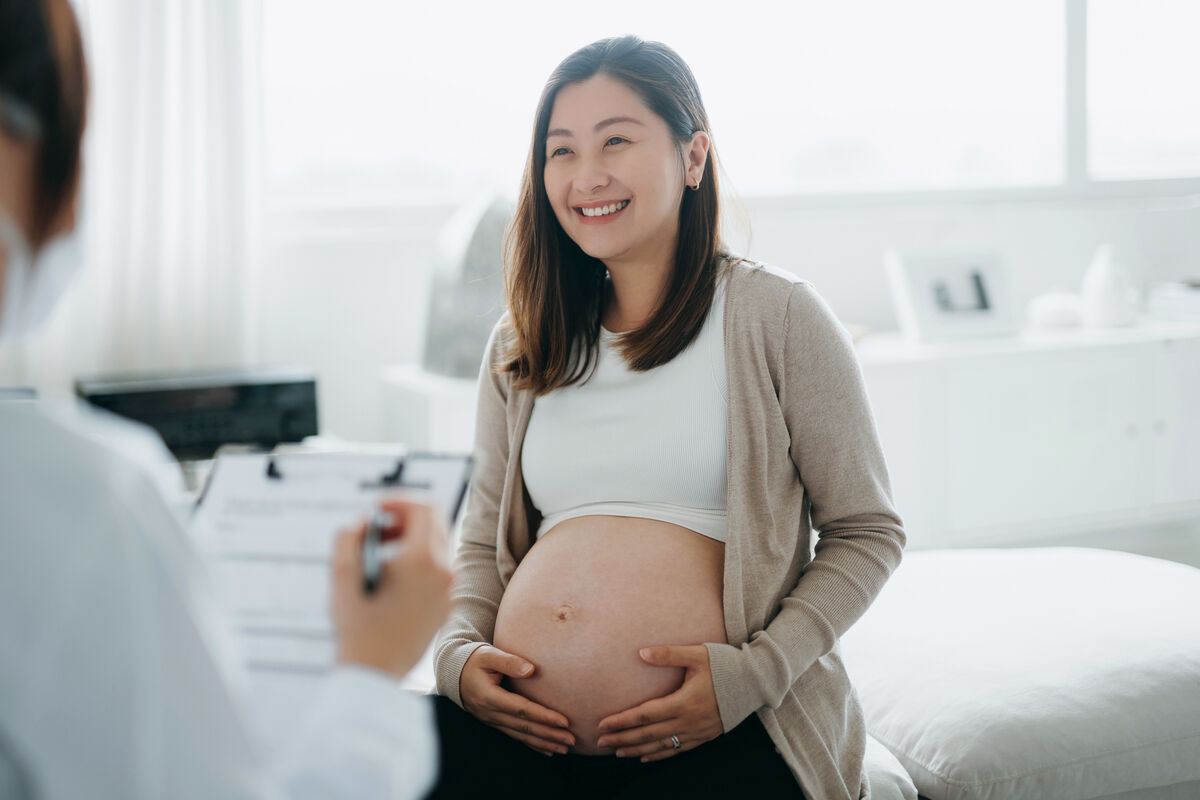 Pregnant woman having a consultation with a female doctor