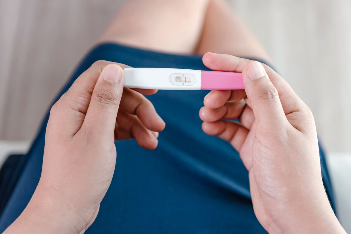 Young Woman Hands Holding a Pregnancy Test