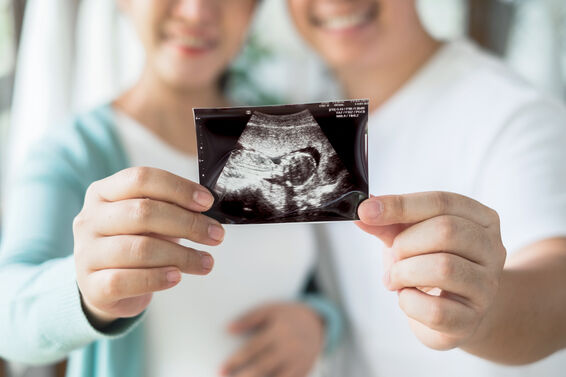 Pregnant couple feeling happy show ultrasound image