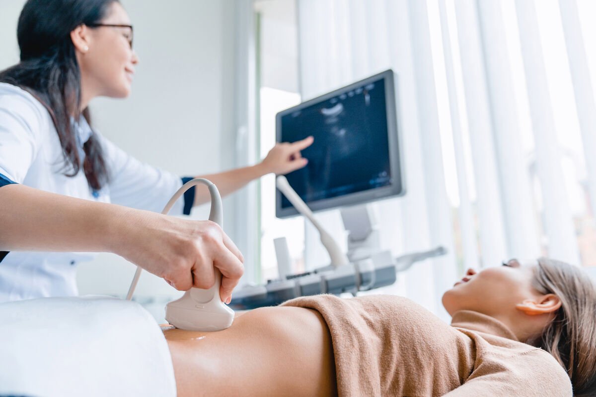 Doctor giving pregnant woman ultrasound