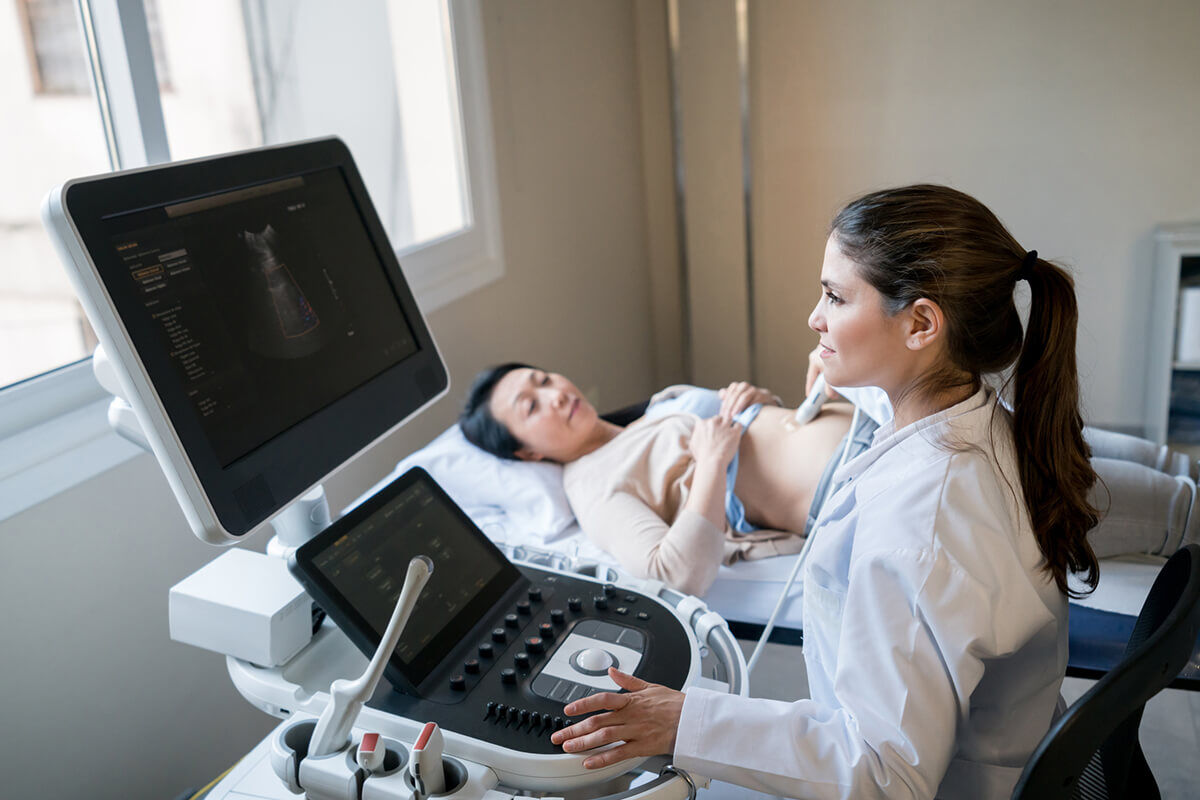 Doctor doing an ultrasound to a female patient