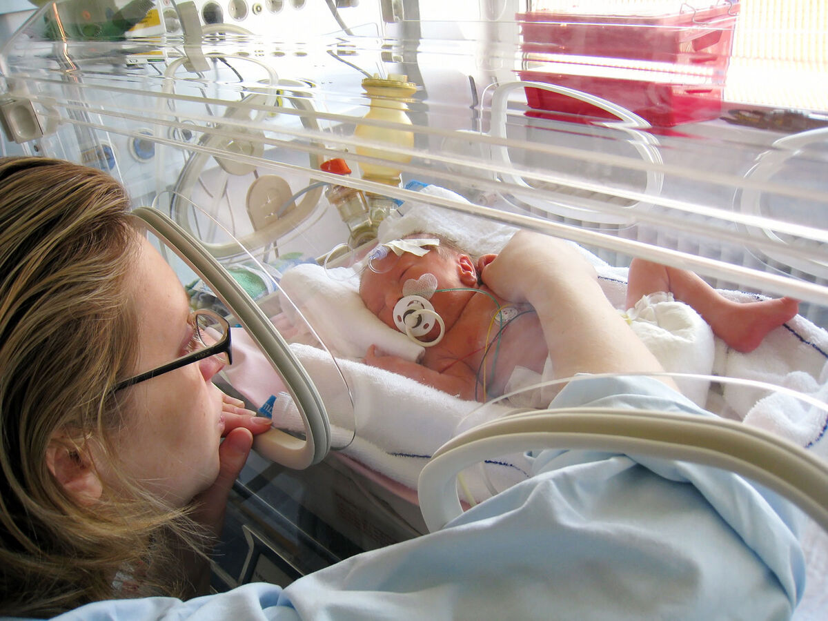 Mother with baby in incubator