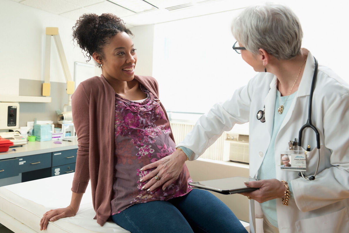 Pregnant woman speaking with doctor