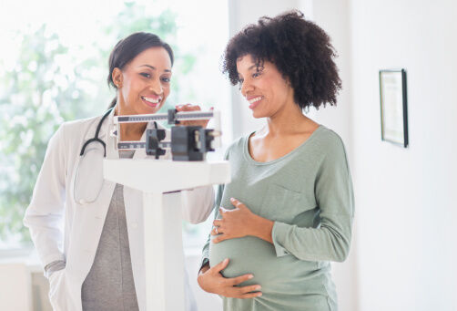 doctor weighing pregnant woman