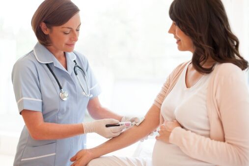 Pregnant woman having blood taken