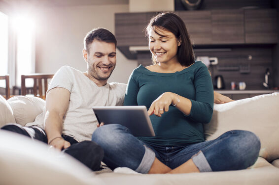 Soon to be parents looking at tablet