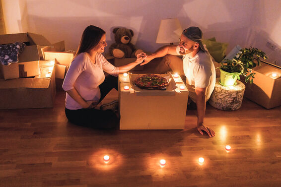 Happy pregnant woman and her husband eating pizza