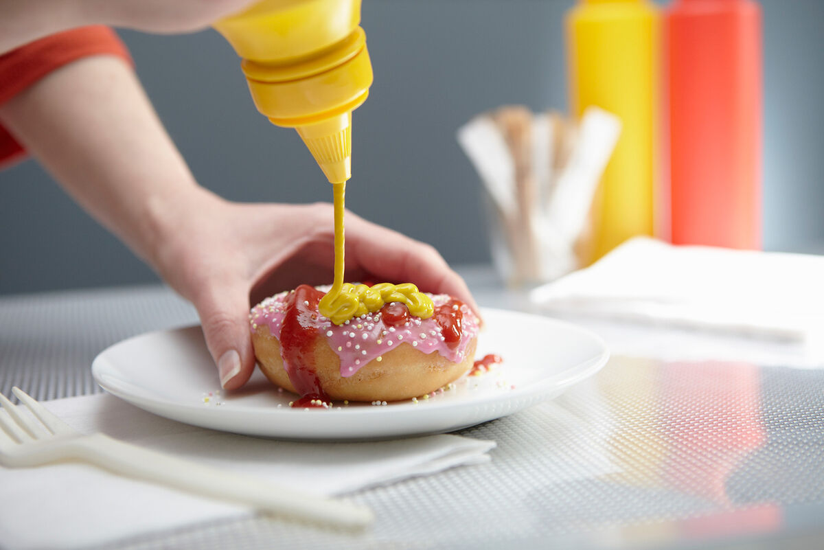 Squirting donut with ketchup and mustard