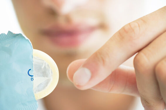 Woman removing condom from wrapper