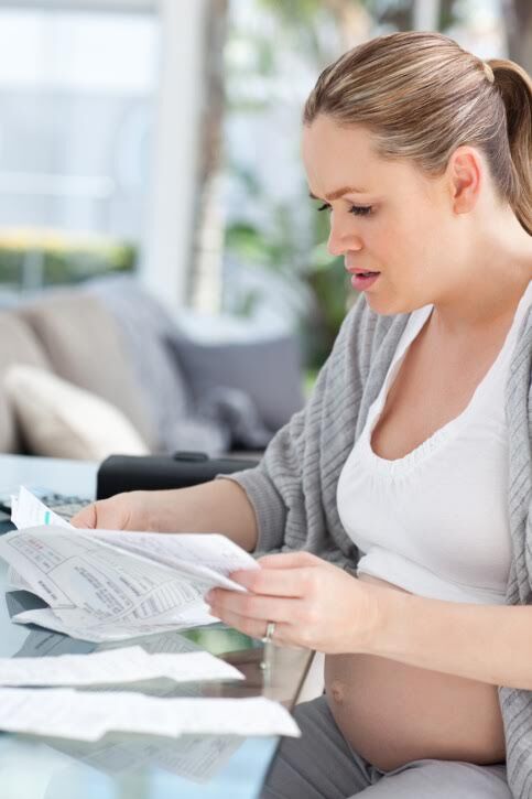 pregnant woman worrying about bills