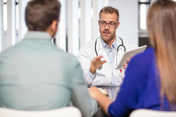 Doctor talking to couple about male birth control methods