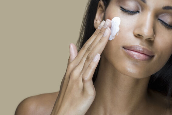 woman applying moisturizer