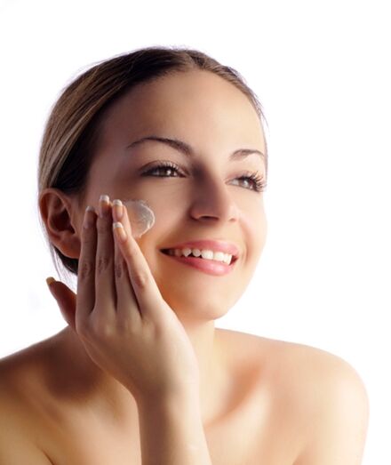woman applying product to face