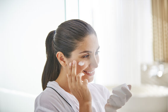 Woman applying face cream