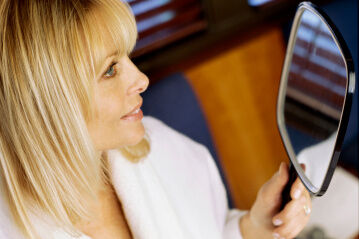 woman looking in mirror