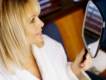 woman looking in mirror