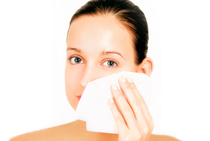 Woman using face wipe