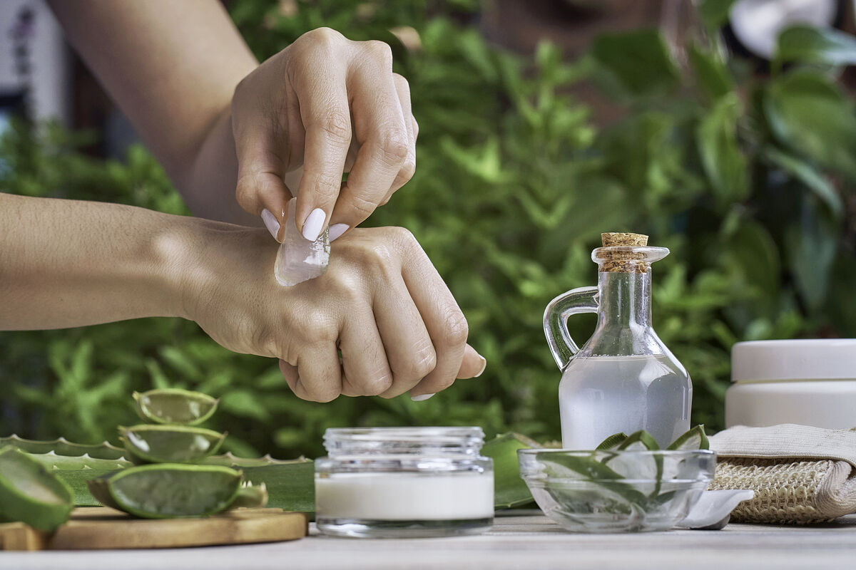 Young woman using aloe vera in her hands