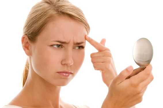 woman looking at a blemish