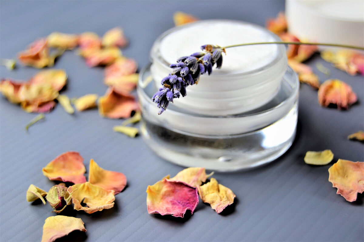 Moisturizer on a table decorated with rose petals