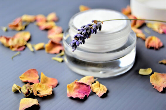 Moisturizer on a table decorated with rose petals