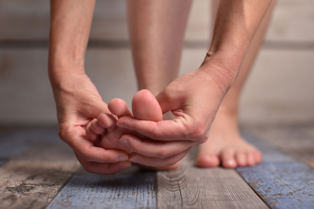 Woman massaging her feet