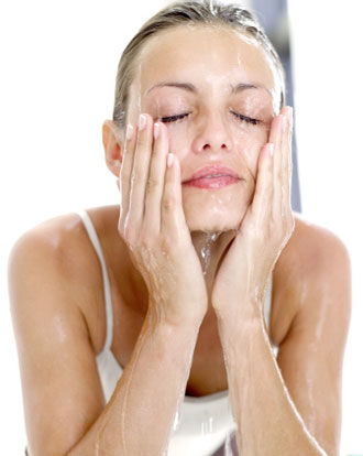Woman washing her face