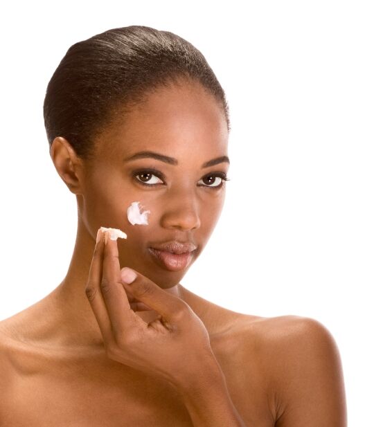 Beautiful woman applying face lift cream