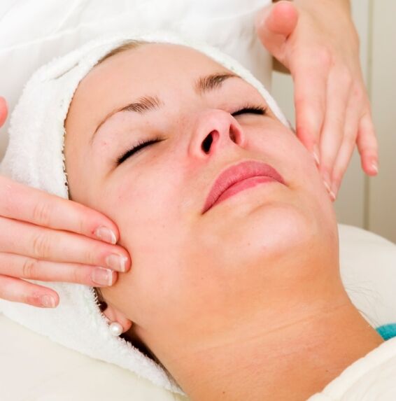 Relaxed woman getting a facial massage