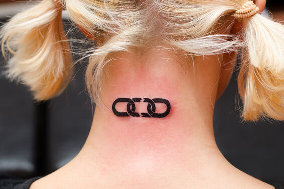 Woman getting broken chain tattoo