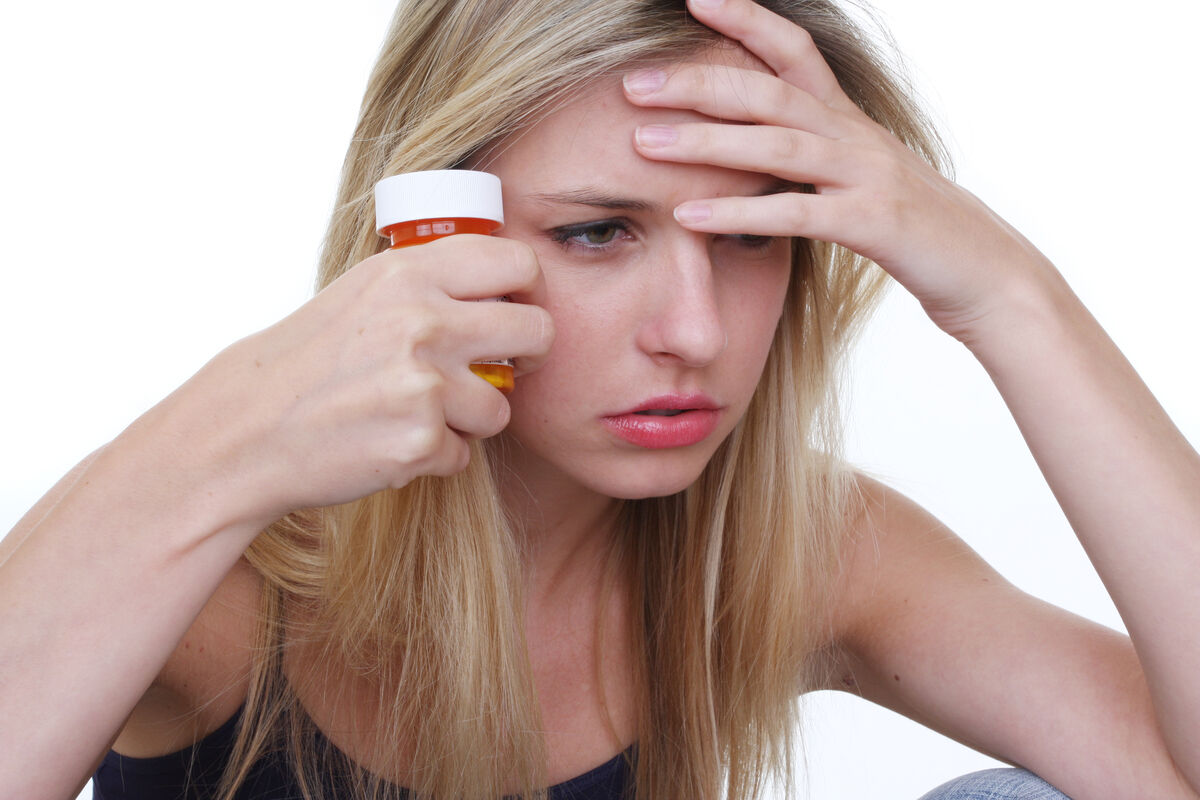 woman with pills in her hand