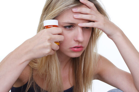 woman with pills in her hand