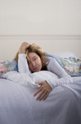Ill woman in bed Source:iStockPhotos.com Permission: Licensed