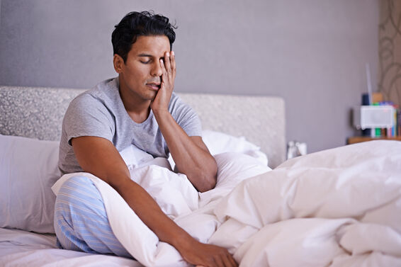 man sitting on bed